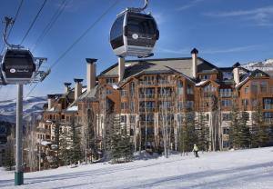 a ski lift in front of a large building at Highlands Slopeside #221 condo in Beaver Creek