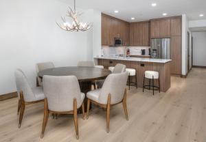 a kitchen and dining room with a table and chairs at Highlands Slopeside #221 condo in Beaver Creek