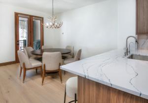 a kitchen and dining room with a table and chairs at Highlands Slopeside #221 condo in Beaver Creek +29 photos