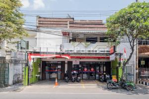 um edifício com motos estacionadas em frente em Swun Stay Inn At Sawahan Mitra RedDoorz em Malang