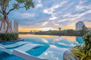 a swimming pool with a view of a city at Convinia Luxury The Peak Midtown in Ho Chi Minh City