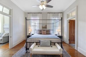 a bedroom with a bed and a ceiling fan at Coastal Cottage with Pool - Restoring Galveston in Galveston