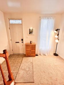 a living room with a door and a window at Cheerful Two Bedroom Central Location Downtown in Baltimore