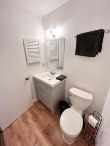 a bathroom with a white toilet and a sink at Cheerful Two Bedroom Central Location Downtown in Baltimore