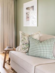 a living room with a couch with pillows on it at Verandah House Country Estate in Mount Tamborine