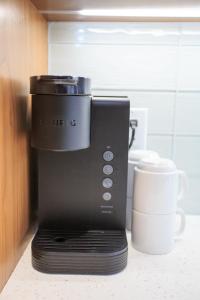 a coffee maker sitting on a counter next to a cup at The Drift in Pagosa Springs