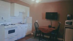 a kitchen with a table and a small table with chairs at Westview Motel in Vegreville