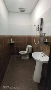 a bathroom with a toilet and a sink at CHILL GUEST HOUSE CENANG in Pantai Cenang