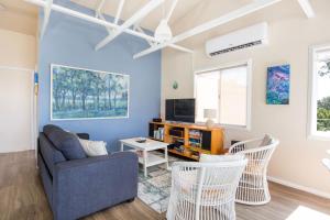 a living room with a couch and chairs at Seahaven - Pet Friendly with Ocean Views- 2 Mins to Beach in Currarong
