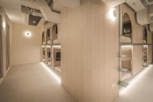 an empty hallway with shelves on the wall at Jyu Capsule Hotel in Singapore