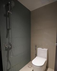 a bathroom with a toilet and a shower at Jyu Capsule Hotel in Singapore