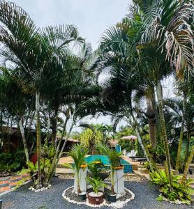 a resort with palm trees and a swimming pool at AJ Paradise Resort Aonang Krabi in Ao Nang Beach