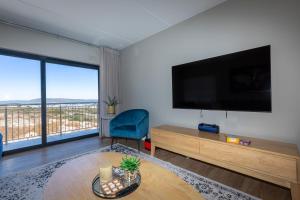 a living room with a large flat screen tv on the wall at Nivica 46 Luxury Apartment Langebaan in Langebaan
