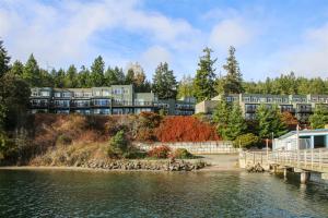 a building on a hill next to a body of water at Sq Orca Oasis in Port Townsend