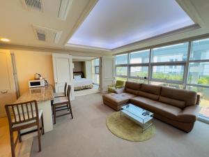a living room with a couch and a table at Busan Centum Victoria hotel in Busan