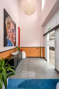 an office lobby with a painting of a man at The Electric Hotel in Geelong