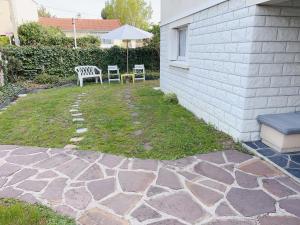 eine Terrasse mit zwei Stühlen und einer Bank im Hof in der Unterkunft 住在巴黎 in Bondy