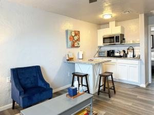 a kitchen with a blue chair and a table at Cozy 1 Bedroom W Rainshower I Mins To Downtown in Oklahoma City