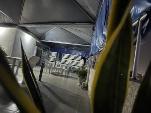 an inside view of a tent with chairs and tables at HOTEL 229 42 in Cotonou