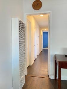 a room with a hallway with a clock on the wall at Modern Stay - Private Room in Long Beach
