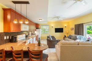 a kitchen and living room with a couch and a table at The Island Cottage-Oceanview-Steps to Grace Bay in Providenciales