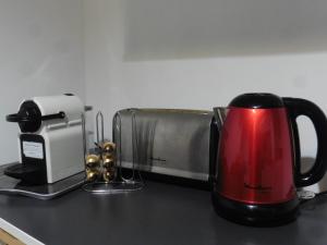 a coffee maker and a toaster on a counter at Au cosy Provençal centre historique Parking public 300m in Aix-en-Provence