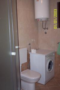 a bathroom with a toilet and a washing machine at Apartment STJEPKO in Cavtat