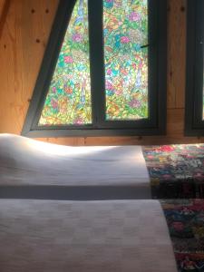 a bedroom with a bed and a stained glass window at Happy House Bungalov Three-Room SPA JAKUZİ Lake view in Sapanca B2 in Sapanca