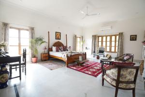 a living room with a couch and a table at Castle Oodeypore A Boutique stay Udaipur in Udaipur