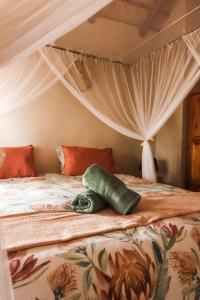 a bed with a stuffed animal laying on it at Bushvilla's Silonque in Phalaborwa