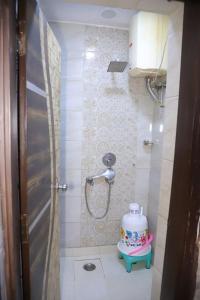 un baño pequeño con ducha y un pastel. en divine India Service Apartment 1Bhk,L-36B,Saket, en Nueva Delhi