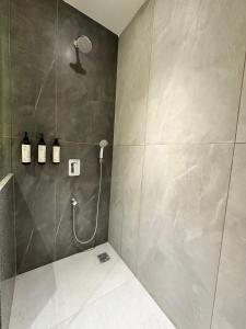 a bathroom with a shower stall with a shower at 32 Urban by Akoya Hotels in Hyderabad