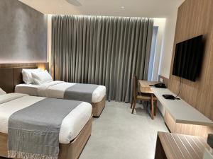 A bed or beds in a room at 32 Urban by Akoya Hotels