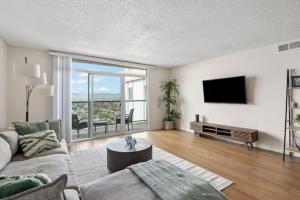a living room with a couch and a flat screen tv at Stunning Ocean View 1BR Venice Beach Marina DelRey in Los Angeles