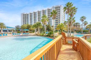 a view of a resort with a pool and a building at Marvelous Palms of Destin Condo with Pool View in Destin