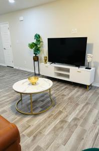 a living room with a tv and a coffee table at Modern apt-King bed-Free parking-Wi-fi in Brownsville