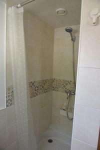a shower with a shower curtain in a bathroom at Gîte sur Grand Fort Philippe in Grand-Fort-Philippe +10 photos