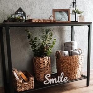 a black shelf with two baskets and a smile sign on it at Wolfpack Guest House in Białka Tatrzańska