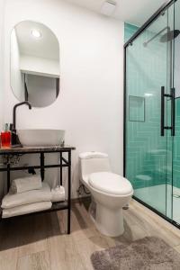 a bathroom with a toilet and a glass shower at Mariano Escobedo 48 in Mexico City