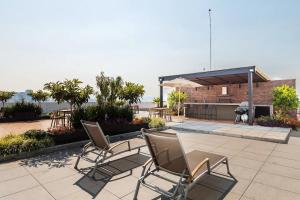 a group of chairs sitting on a patio at Mariano Escobedo 48 in Mexico City