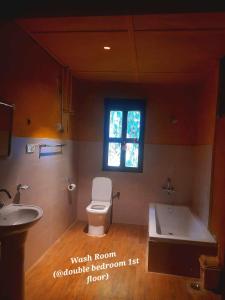 a bathroom with a toilet and a sink and a tub at Nobgang B&B "Traditional Heritage HomeStay" in Punākha