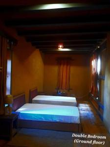 a large bed in a room with a red curtain at Nobgang B&B "Traditional Heritage HomeStay" in Punākha