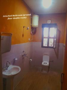 a bathroom with a sink and a toilet and a window at Nobgang B&B "Traditional Heritage HomeStay" in Punākha