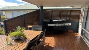 a patio with a grill and a table on a deck at Island View 2 in Coffin Bay