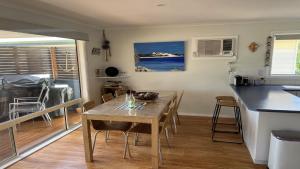 a kitchen and dining room with a table and chairs at Island View 2 in Coffin Bay