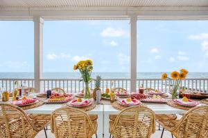 a table with food and a view of the ocean at Poseidon By AvantStay On The Beach Two Ocean Facing Balconies Hot Tub in Folly Beach