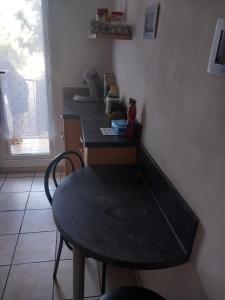 a kitchen with a table and a table and a table and a window at Chambre A2 dans un appartement en colocation in Marseille