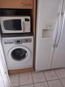 a kitchen with a microwave and a refrigerator at Chambre A2 dans un appartement en colocation in Marseille