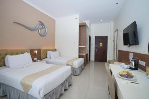Voodi või voodid majutusasutuse Lorin Syariah Hotel Sentul toas