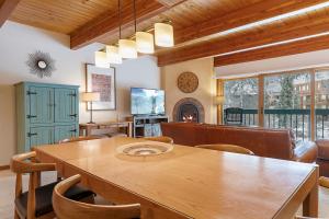 a dining room with a wooden table and chairs at Riverside Condos D01 by AvantStay Condo Close To Downtown Town Park Ski Lift 8 in Telluride